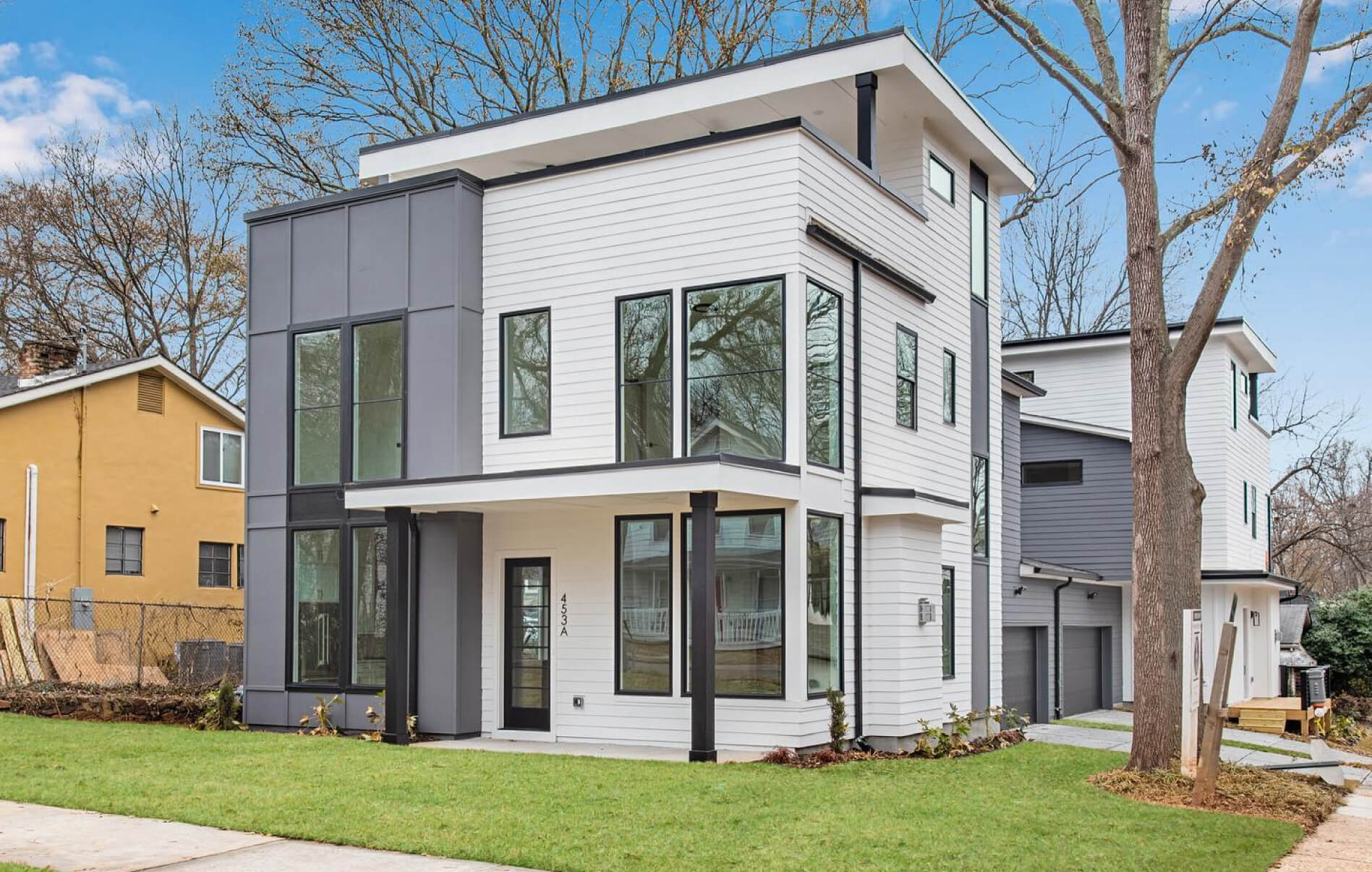 SES siding installation — white and gray modern townhome community exterior